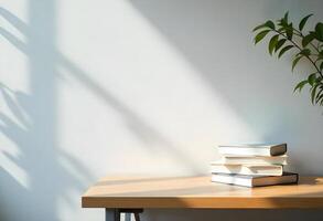 A stack of books on a table in front of a window photo