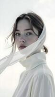 A woman in white is posing for a photo