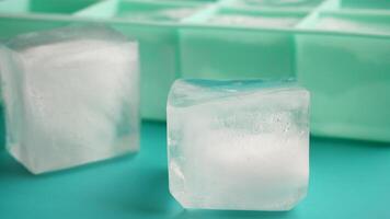 Ice cubes forming in a tray on a flat surface video