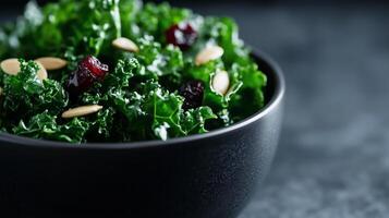 A bowl of kale salad with cranberries and almonds photo