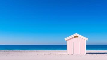 A pink beach hut on the beach with blue sky photo