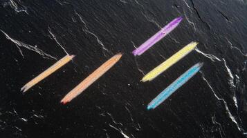 A chalkboard with a chalk drawing of a rainbow photo
