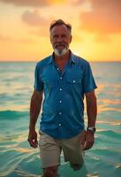 A man in a blue shirt standing in the ocean photo