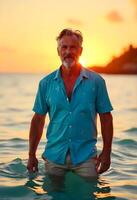 A man standing in the water at sunset photo