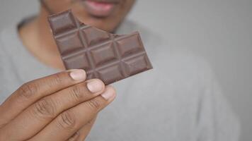 Holding a piece of chocolate before tasting video