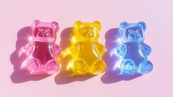 Three gummy bears on a pink surface photo