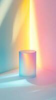Abstract glass cylinder illuminated by vibrant gradient lights creating a spectrum of pastel colors in a minimalistic setting photo