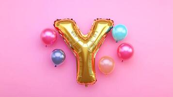 Golden letter Y balloon surrounded by colorful balloons on a vibrant pink background, creating a festive atmosphere for celebrations and special occasions photo