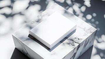 A white square box sitting on top of a marble surface photo