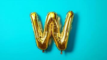 Golden balloon letter W on a vibrant turquoise background, creating a playful and festive atmosphere, ideal for celebrations and creative design projects photo