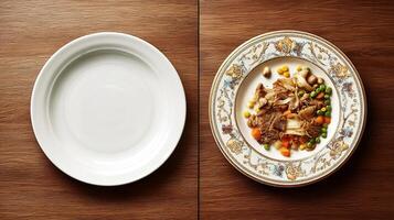 Empty white plate beside a beautifully arranged dish of colorful vegetables and meat on a decorative plate, showcasing culinary presentation and dining experience photo