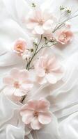 Delicate pink flowers arranged elegantly on soft white fabric, showcasing natural beauty and texture, perfect for floral design and aesthetic inspiration in various creative projects photo
