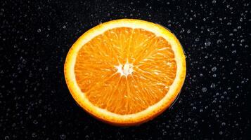 A juicy half orange on a dark background photo