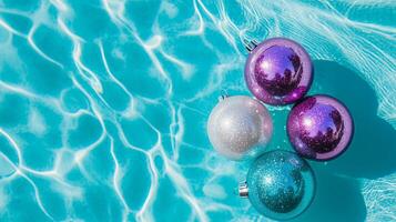 Three ornaments floating in a pool of water photo
