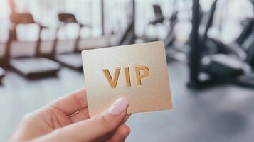 womans hand holding a golden business card photo