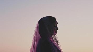 A silhouette of a bride in a veil photo