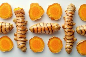 Fresh Turmeric Roots and Slices Arranged on White Background photo
