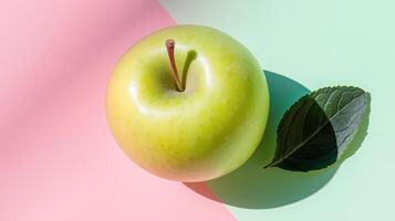 Green apple on pink and green background photo