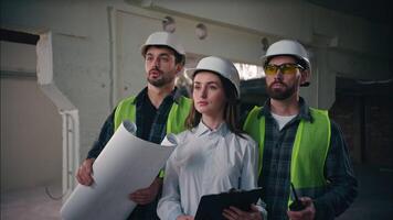 Surprised Caucasian builders woman men working inspect building in construction contractors engineers shock awe emotion guys supervisors controllers looking finished project manufactory architecture video