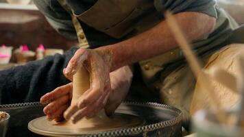 Man create new clay product sculpting modeling vase jug pot bowl master male professional craftsman seller creator potter pottery small business artisan in workshop hobby handicraft handwork clayware video