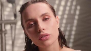 Calm attractive pretty Caucasian woman girl female naked relaxing in bubble foam bath tub enjoying peaceful self care routine spa at home bathroom indoors beauty procedure comfort looking at camera video