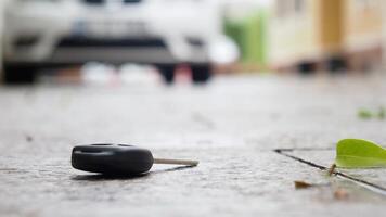 Lost car key resting on the ground near a vehicle video