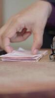 Cash counting on a wooden table with tools in focus video