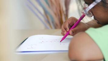 Child practicing writing in colorful study area video
