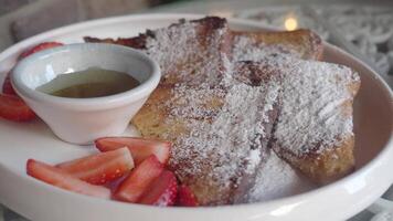 Enjoying delicious French toast with strawberries and syrup video