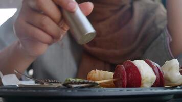 Enjoying delicious skewers with a sprinkle of seasoning video