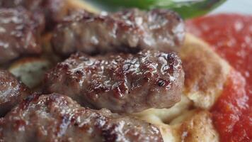 Grilled meat served with tomato and bread video