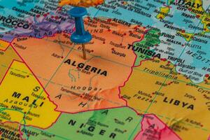 Pinpointing Algeria on a colorful world map photo