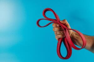 Brightly colored resistance bands held by a person's hand photo