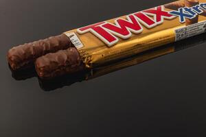 Lviv Ukraine 05.06.25 Chocolate candy bar displayed on a reflective surface photo
