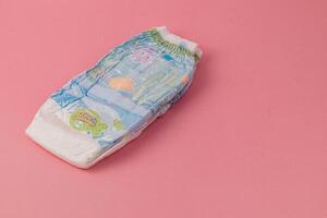 Lviv Ukraine 05.06.25 Colorful baby diaper on a pink background ready for use photo