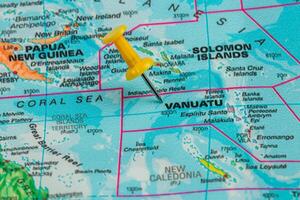 Vanuatu marked on a world map with a yellow pushpin photo