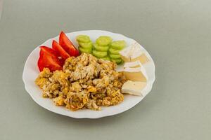 Savory plate of scrambled eggs with fresh vegetables photo