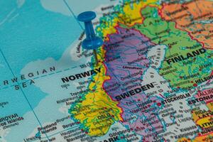 Colorful map highlighting Norway and Sweden with a pushpin photo