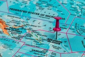 Exploring Solomon Islands on a colorful world map photo