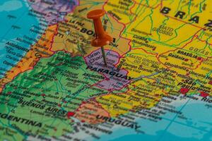 Exploring Paraguay on a colorful map with a pin photo