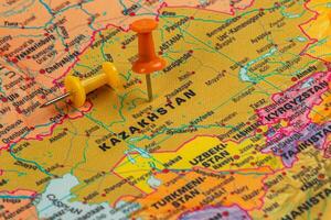 Map highlighting Kazakhstan with colorful push pins attached photo