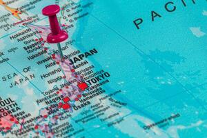Discovering Japan on a colorful map with a pin marking Tokyo photo