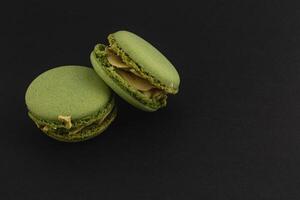 Delicious green macarons on a dark background photo