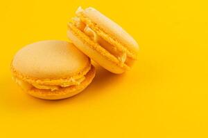 Bright yellow macarons on a vibrant background photo