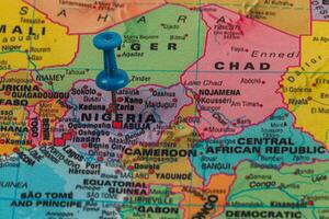 Location pin highlighting Nigeria on a colorful map photo
