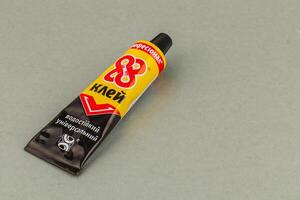 Lviv Ukraine 05.22.25 Universal adhesive tube on a gray surface for crafts photo