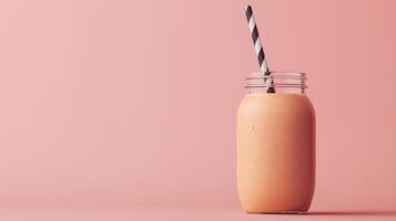 glass jar with a black and white striped straw. The jar is filled with a brown smoothie or milkshake. The background is a light brown color photo