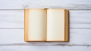 open old book or magazine lying on a white wooden surface. The book appears to be blank, with no text or images on the pages photo
