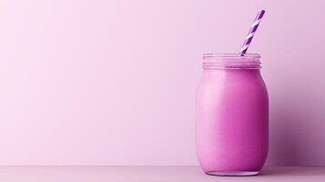 glass jar with a violet and white striped straw. The jar is filled with a purple smoothie or milkshake. The background is a light purple color photo