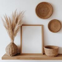 wooden shelf against a white wall. On the shelf, there is a rectangular wooden frame with a blank white background. photo